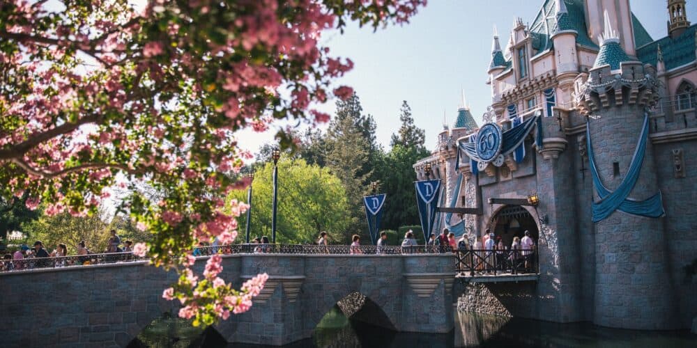 Disneyland castle with 60th anniversary banners