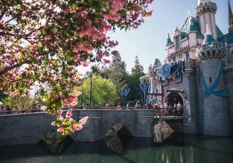 Disneyland castle with 60th anniversary banners