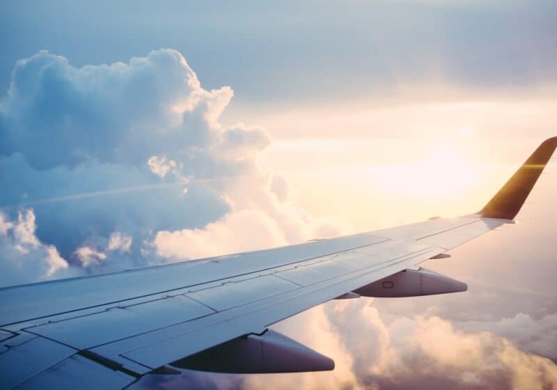 Airplane wing in the air surrounded by clouds