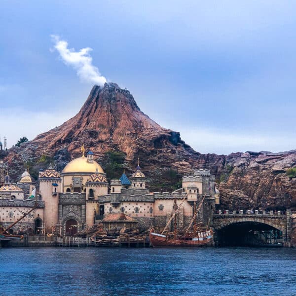 A smoking volcano with a city view and a lake in Tokyo DisneySea