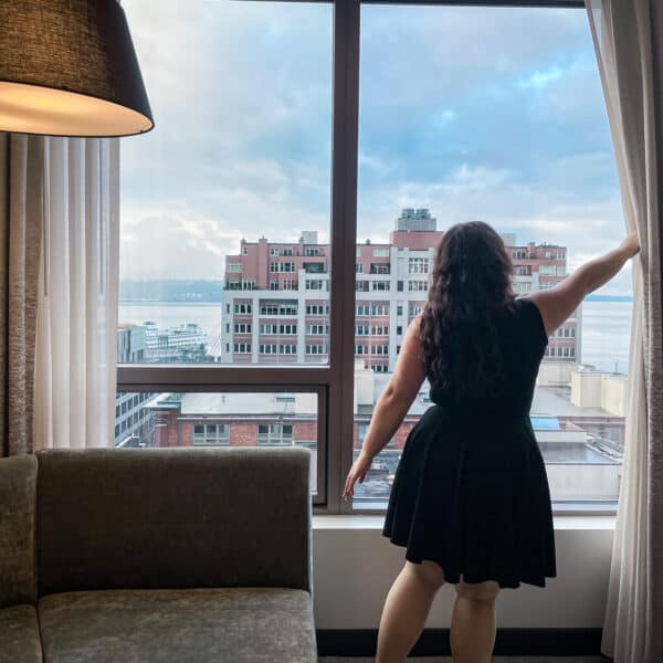 Girl standing at a window, starring at the city