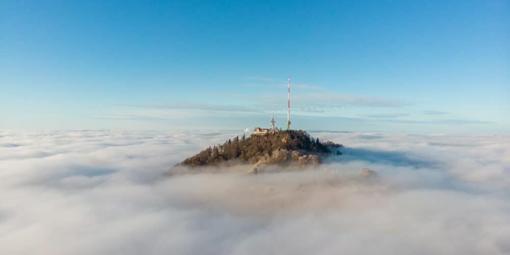 Top of mountain protruding from the clouds