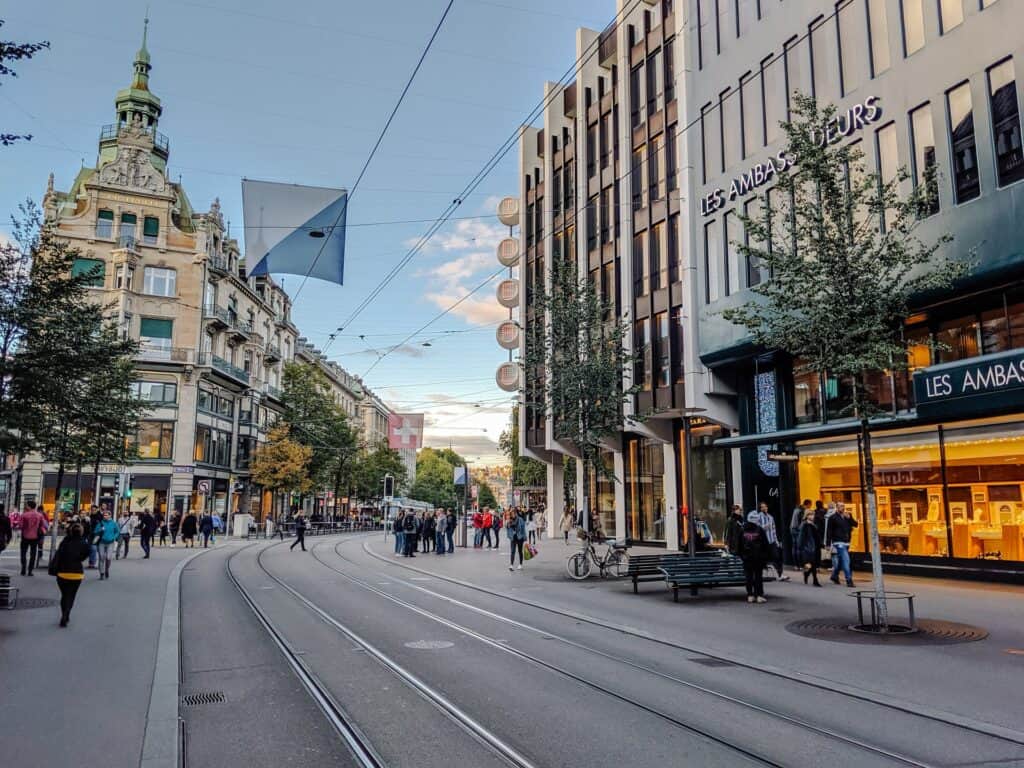 People walking down Bahnhofstrasse shopping street with pretty buildings in Zurich