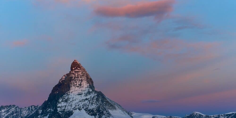 Matterhorn mountain peak against a colorful sky from Gornergrat Station